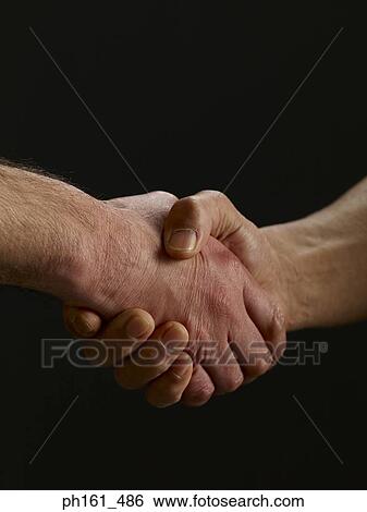 Two men shaking hands, close-up View Large Photo Image Stock Photograph - Two men shaking hands, close-up. Fotosearch