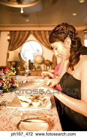 Stock Image - Two women enjoying a meal. Fotosearch