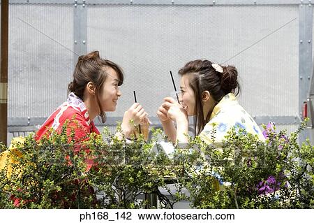 Two women having a meal, smiling View Large Photo Image Stock Image - Two women having a meal, smiling. Fotosearch