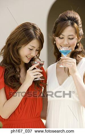 Two women having cocktails View Large Photo Image Stock Photo - Two women having cocktails. Fotosearch