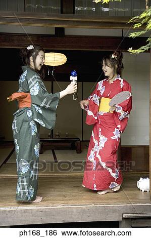 Two women in kimono having fun View Large Photo Image Stock Photograph - Two women in kimono having fun . Fotosearch