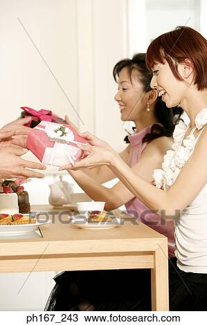 Stock Image - Two women receiving gifts . Fotosearch