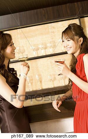 Stock Photo - Two women relaxing by the bar. Fotosearch