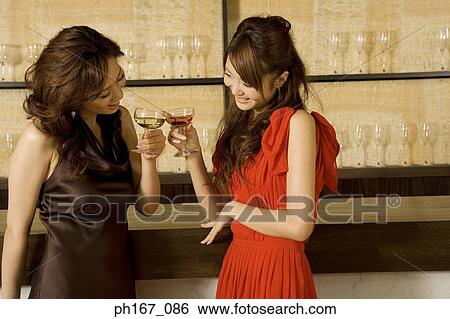 Stock Photograph - Two women toasting. Fotosearch