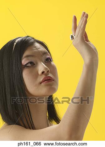 Stock Photograph - Woman admiring ring on her hand. Fotosearch