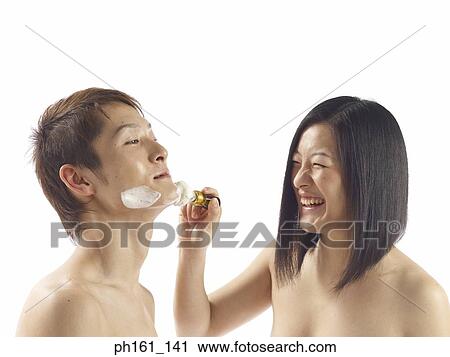 Woman applying shaving cream on man's face View Large Photo Image Stock Image - Woman applying shaving cream on man's face. Fotosearch