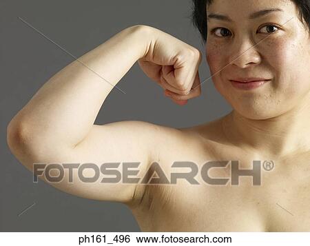 Stock Photograph - Woman flexing her muscles. Fotosearch