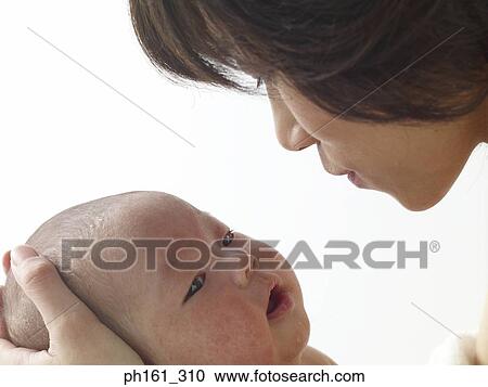Woman holding a baby lovingly View Large Photo Image Stock Image - Woman holding a baby lovingly. Fotosearch