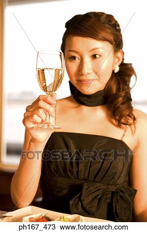 Woman holding a glass of wine View Large Photo Image Stock Image - Woman holding a glass of wine. Fotosearch