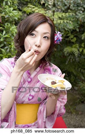Woman in kimono enjoying dessert in the garden View Large Photo Image Stock Photography - Woman in kimono enjoying dessert in the garden. Fotosearch