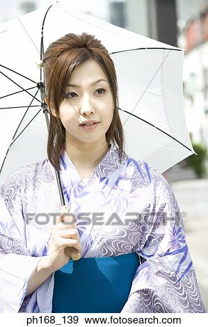 Woman in kimono, holding an umbrella View Large Photo Image Stock Photo - Woman in kimono, holding an umbrella. Fotosearch
