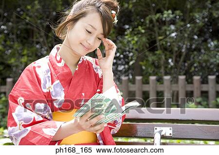 Stock Photography - Woman in kimono reading a book. Fotosearch