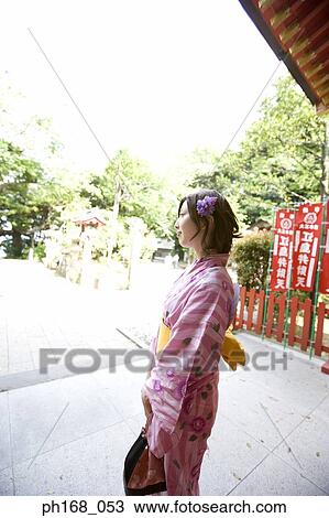 Woman in kimono standing outside temple View Large Photo Image Stock Image - Woman in kimono standing outside temple. Fotosearch