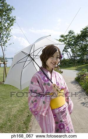 Woman in kimono with umbrella View Large Photo Image Stock Photo - Woman in kimono with umbrella. Fotosearch