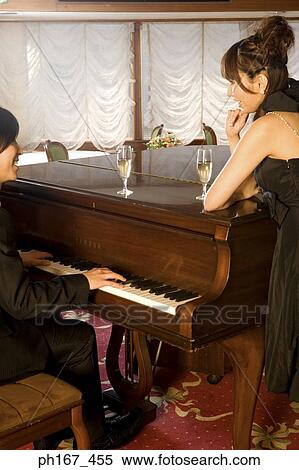 Woman looking at man playing piano View Large Photo Image Stock Photography - Woman looking at man playing piano. Fotosearch