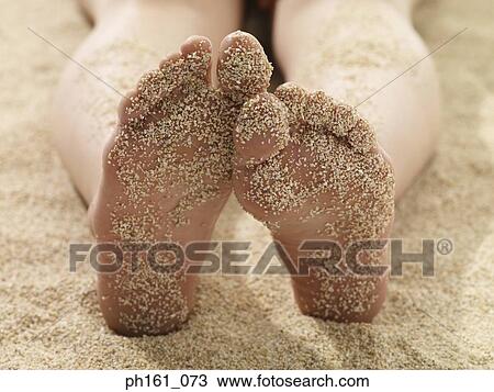 Stock Image - Woman lying on beach. Fotosearch