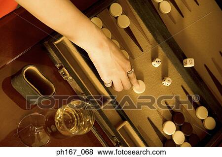 Stock Photo - Woman playing backgammon, high angle view. Fotosearch