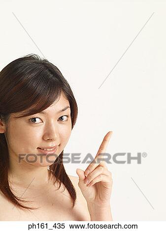Woman pointing up and smiling View Large Photo Image Stock Photography - Woman pointing up and smiling. Fotosearch