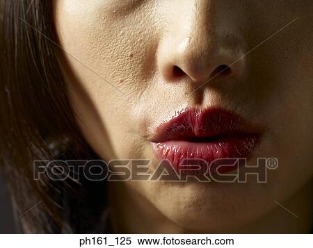Stock Photography - Woman pouting, close-up. Fotosearch