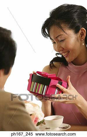 Woman receiving a gift View Large Photo Image Stock Photography - Woman receiving a gift . Fotosearch