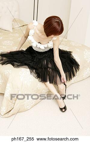 Woman sitting on edge of bed View Large Photo Image Stock Photography - Woman sitting on edge of bed. Fotosearch