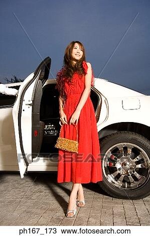 Woman standing next to limousine View Large Photo Image Stock Image - Woman standing next to limousine. Fotosearch