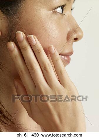 Woman touching her face, side profile View Large Photo Image Stock Image - Woman touching her face, side profile. Fotosearch
