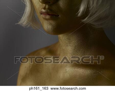 Woman wearing a blonde wig with gold paint on her face and body View Large Photo Image Stock Image - Woman wearing a blonde wig with gold paint on her face and body . Fotosearch
