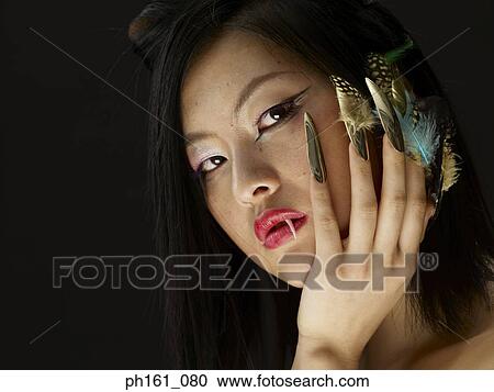 Woman with a fang and feathers on finger nails View Large Photo Image Stock Image - Woman with a fang and feathers on finger nails. Fotosearch