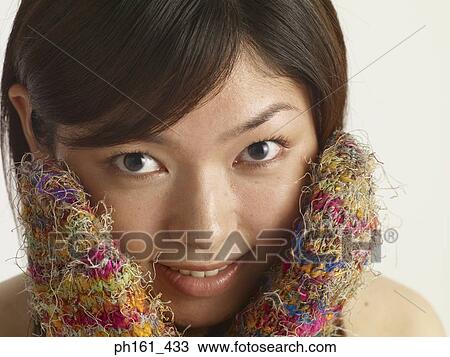 Woman with colorful mittens, covering her face View Large Photo Image Stock Image - Woman with colorful mittens, covering her face. Fotosearch