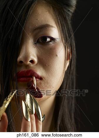 Woman with fang and gold finger nails, close-up View Large Photo Image Stock Photograph - Woman with fang and gold finger nails, close-up. Fotosearch