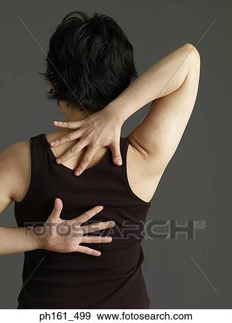 Woman with hands behind her back, stretching, rear view View Large Photo Image Stock Photo - Woman with hands behind her back, stretching, rear view. Fotosearch