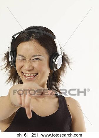 Stock Image - Woman with headphones, dancing. Fotosearch