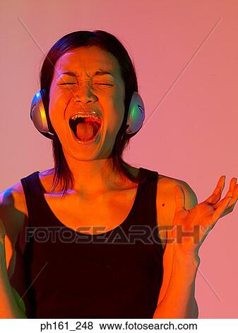 Woman with headphones, screaming View Large Photo Image Stock Photo - Woman with headphones, screaming. Fotosearch