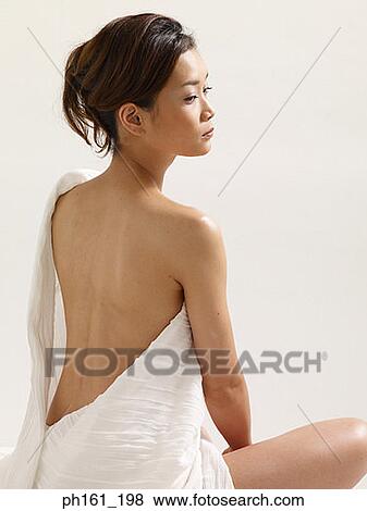Woman wrapped in white cloth, sitting down, rear view View Large Photo Image Stock Photo - Woman wrapped in white cloth, sitting down, rear view. Fotosearch