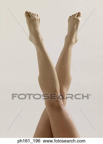 Woman's legs up in the air, crossed at knee View Large Photo Image Stock Photograph - Woman's legs up in the air, crossed at knee. Fotosearch