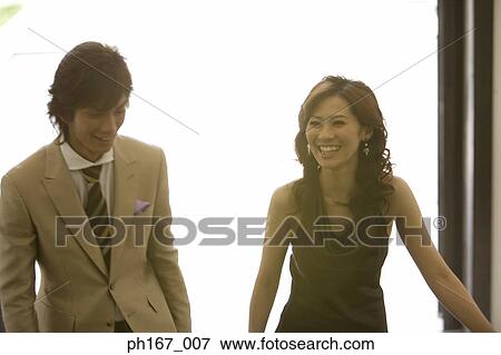 Young couple walking View Large Photo Image Stock Photo - Young couple walking . Fotosearch