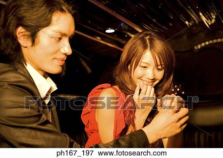Young man holding a woman's hand in a limousine View Large Photo Image Stock Photo - Young man holding a woman's hand in a limousine. Fotosearch