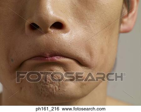 Young man making a face, close-up View Large Photo Image Stock Photograph - Young man making a face, close-up. Fotosearch
