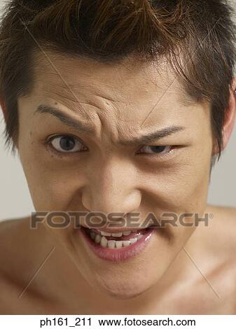 Young man making a face View Large Photo Image Stock Image - Young man making a face. Fotosearch