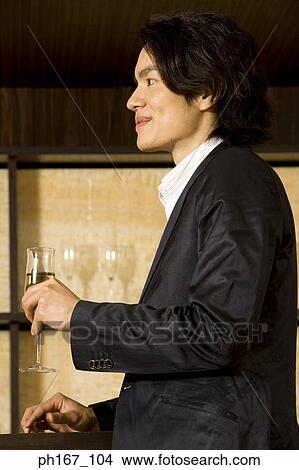 Young man relaxing by the bar View Large Photo Image Picture - Young man relaxing by the bar. Fotosearch