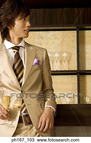 Young man relaxing by the bar View Large Photo Image Stock Image - Young man relaxing by the bar. Fotosearch