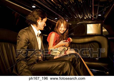Young man with woman holding a gift and flowers View Large Photo Image Stock Photograph - Young man with woman holding a gift and flowers. Fotosearch