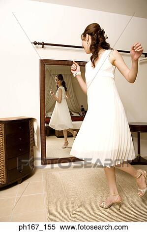 Young woman dancing in front of mirror View Large Photo Image Stock Photography - Young woman dancing in front of mirror. Fotosearch