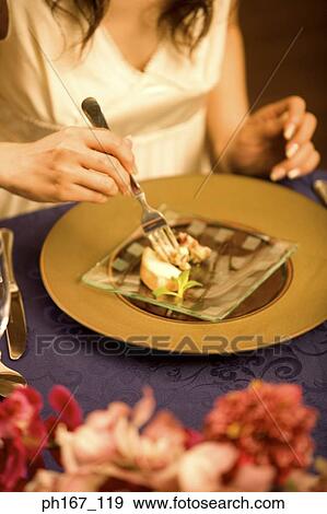 Stock Photo - Young woman having dinner, close-up. Fotosearch