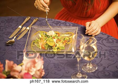 Young woman having salad, close-up View Large Photo Image Stock Photo - Young woman having salad, close-up. Fotosearch
