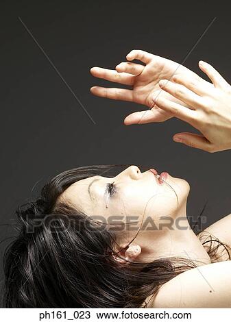 Young woman looking up with hands in the air View Large Photo Image Stock Image - Young woman looking up with hands in the air. Fotosearch