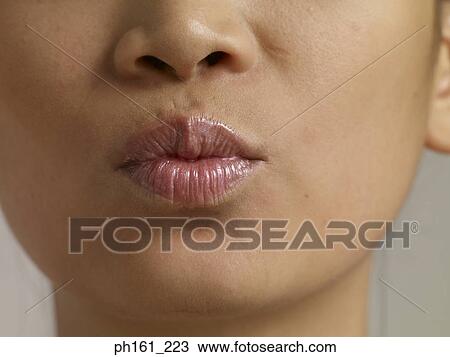 Young woman puckering lips, close-up View Large Photo Image Stock Image - Young woman puckering lips, close-up. Fotosearch