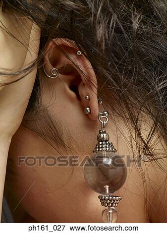 Young woman with earrings, close-up View Large Photo Image Stock Photo - Young woman with earrings, close-up. Fotosearch