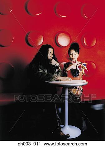 Asian couple at a café table View Large Photo Image Stock Image - Asian couple at a café table. Fotosearch